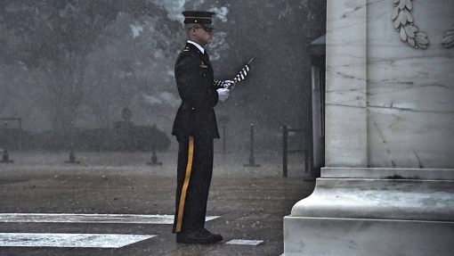 Soldier seen placing flag at Tomb of Unknown Soldier during torrential rain